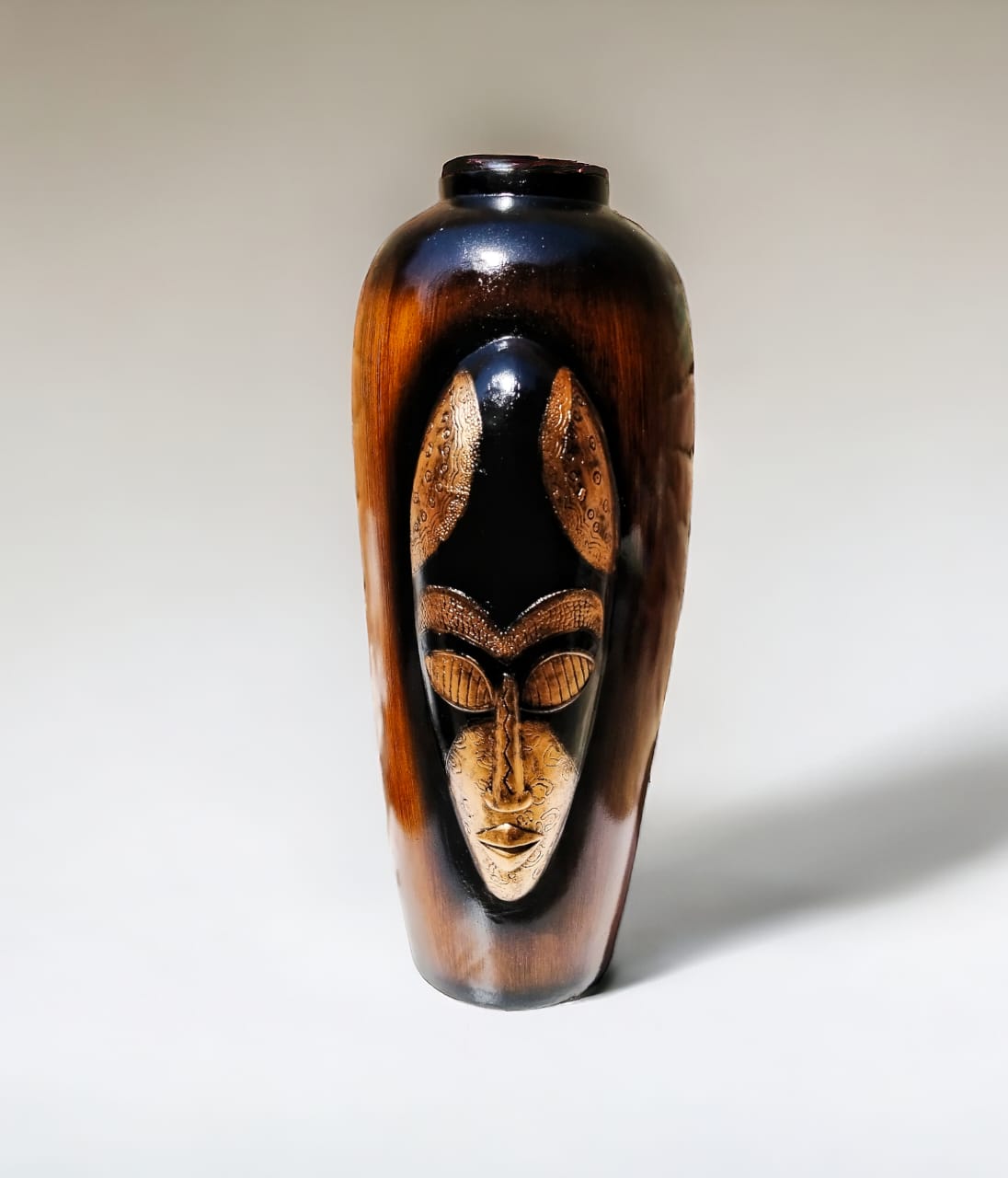 carved face wood-finish bottle vase